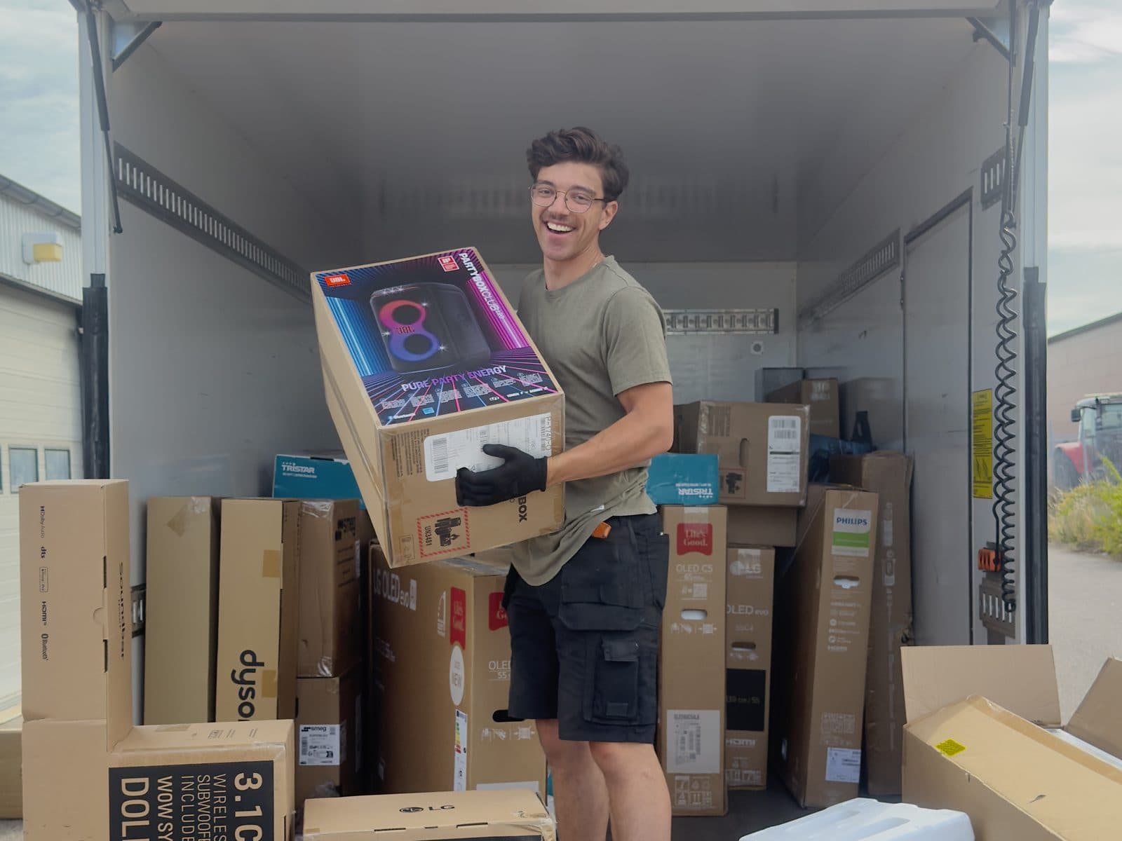 Packaged home electronics being unloaded from a lorry after a store claim — products intact and ready for claims verification